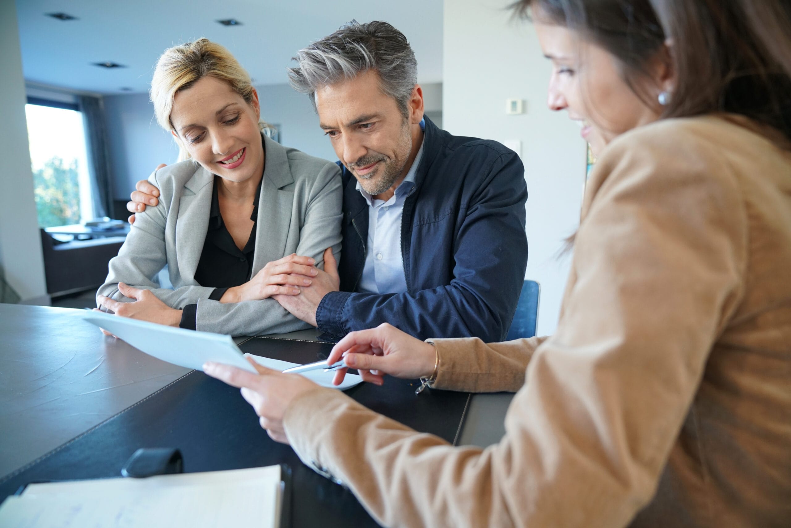 Real-estate agent reading terms of contract to clients